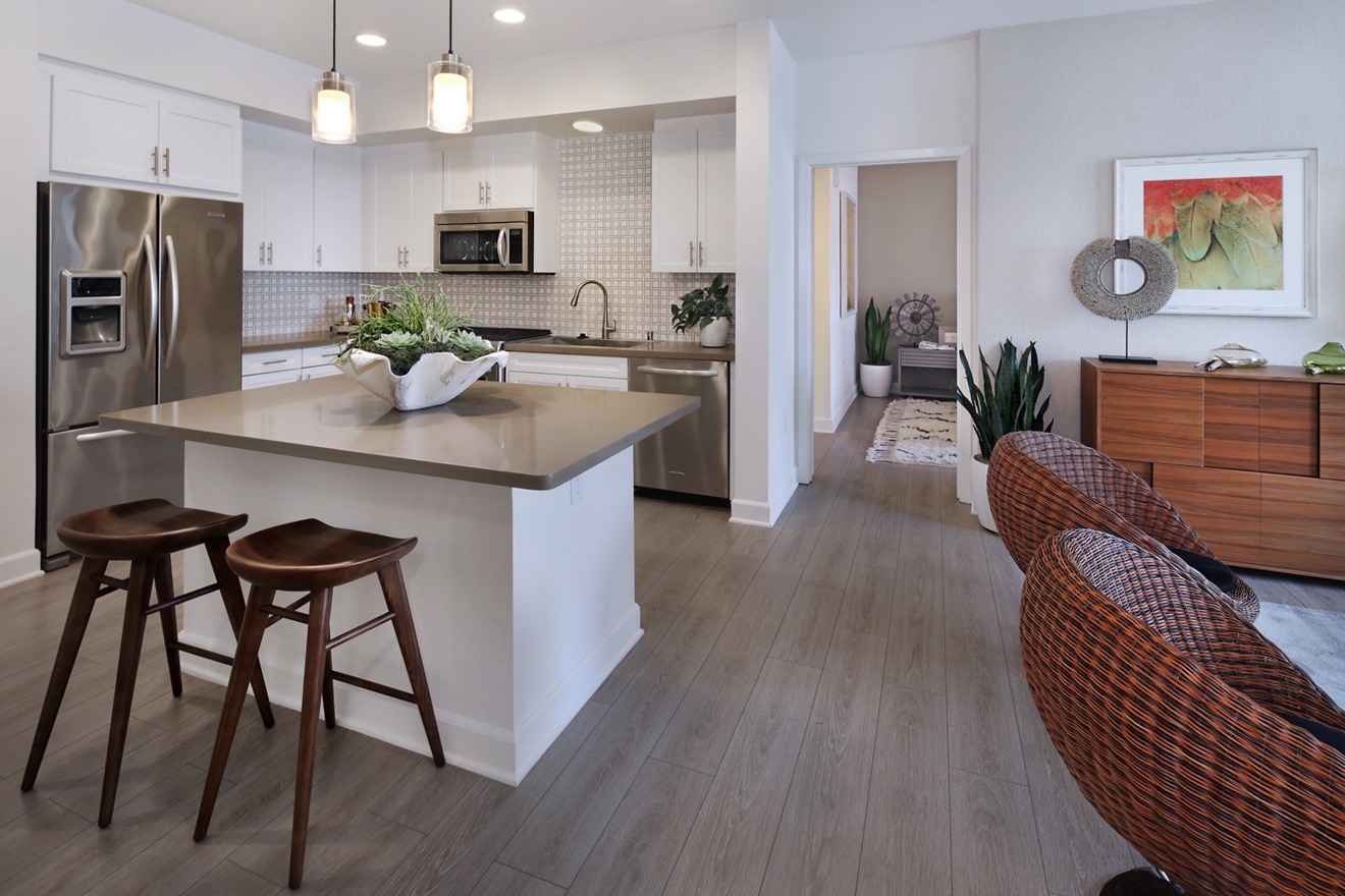 Interior view of living area and kitchen at Malibu - Villas Playa Vista Apartment Homes in Los Angeles, CA.