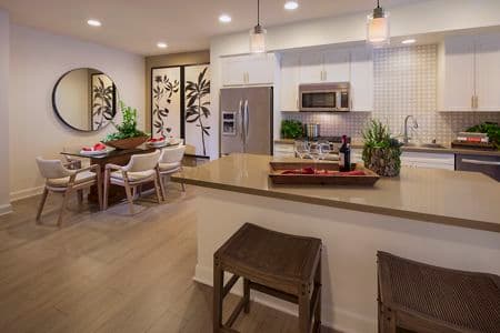 Interior view of dining room and kitchen at Malibu - Villas Playa Vista Apartment Homes in Los Angeles, CA.