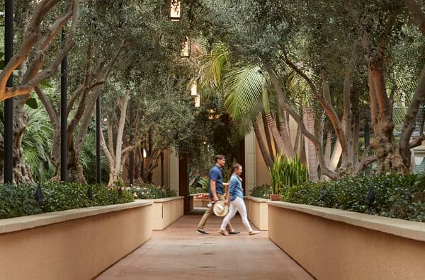 Exterior view of couple walking at Malibu - Villas at Playa Vista Apartment Homes in Playa Vista, CA.