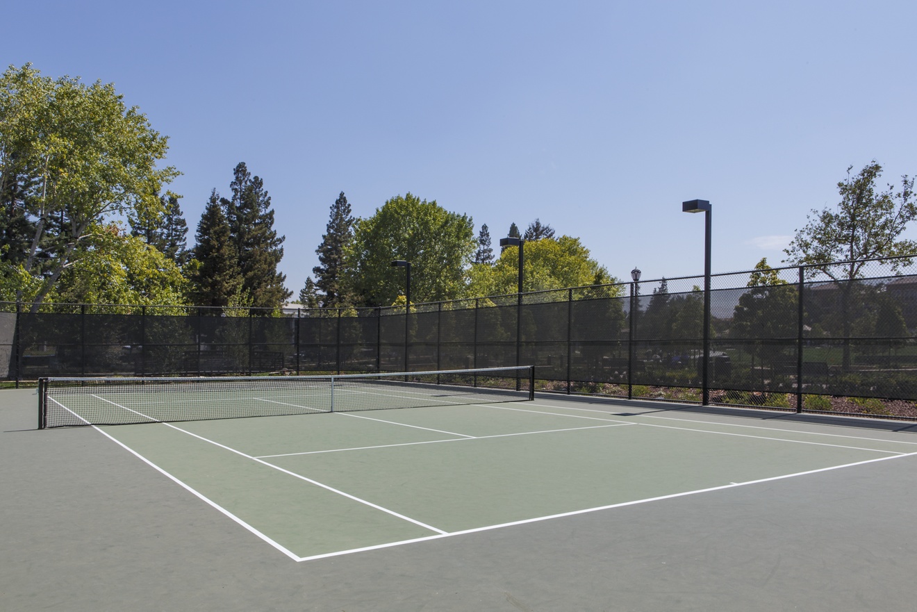 Detail view of a tennis court at River Oaks Park at Crescent Village Apartment Homes in San Jose, CA.