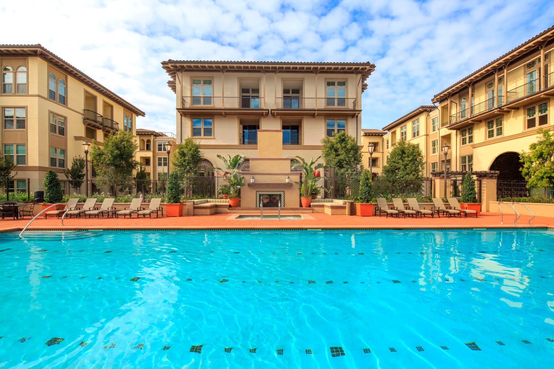View of building exterior and pool at Verona at Crescent Village Apartment Homes in San Jose, CA.