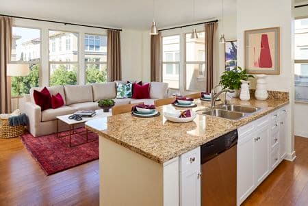 Interior view of Kitchen and Living Room at Crescent Village Apartment Homes in San Jose, CA.