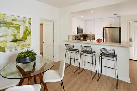 Interior view of kitchen and dining at The Oaks at North Park Apartment Homes in San Jose, CA.