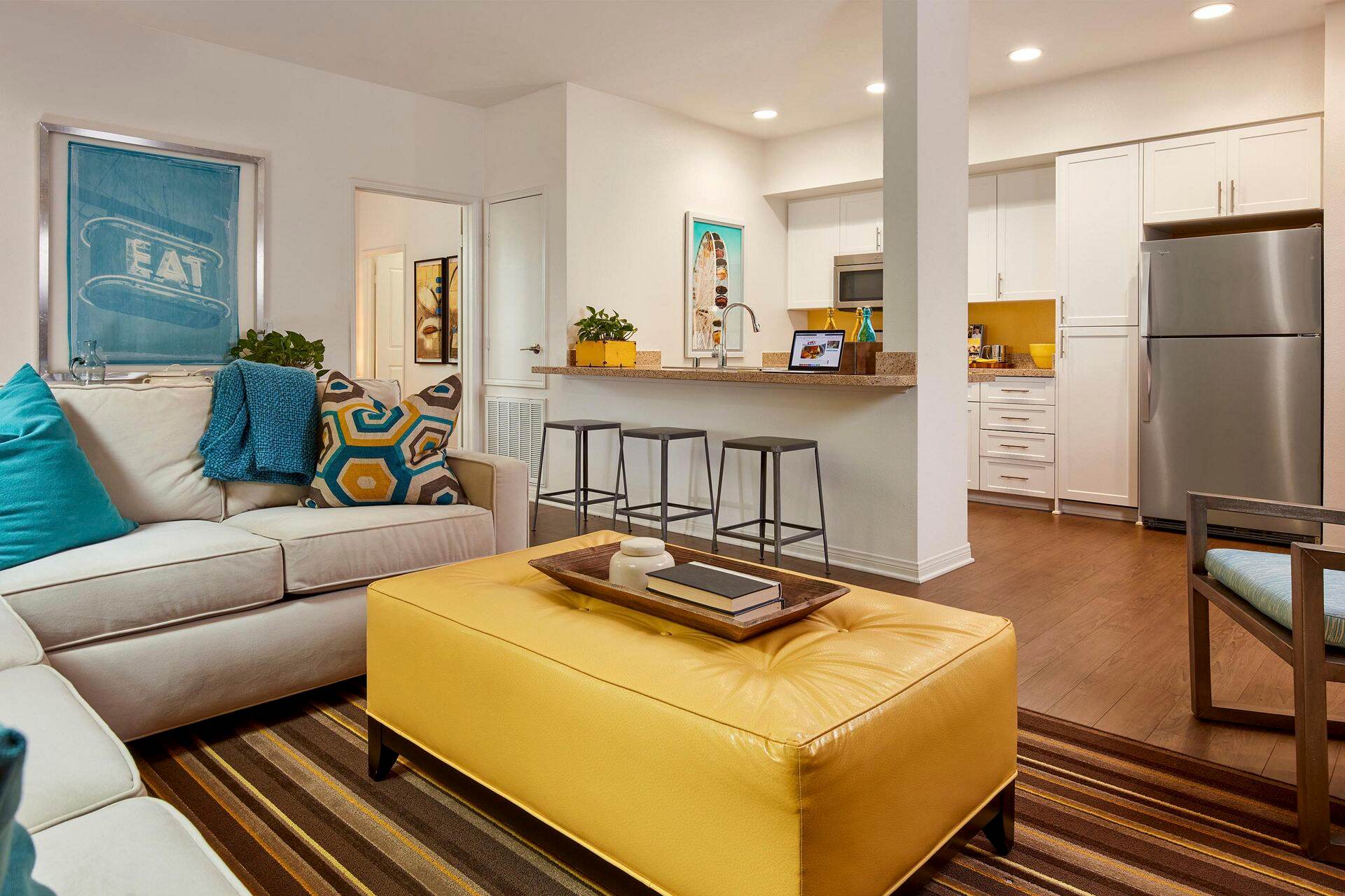Interior view of living room and kitchen at Stewart Village Apartment Homes in Sunnyvale, CA.
