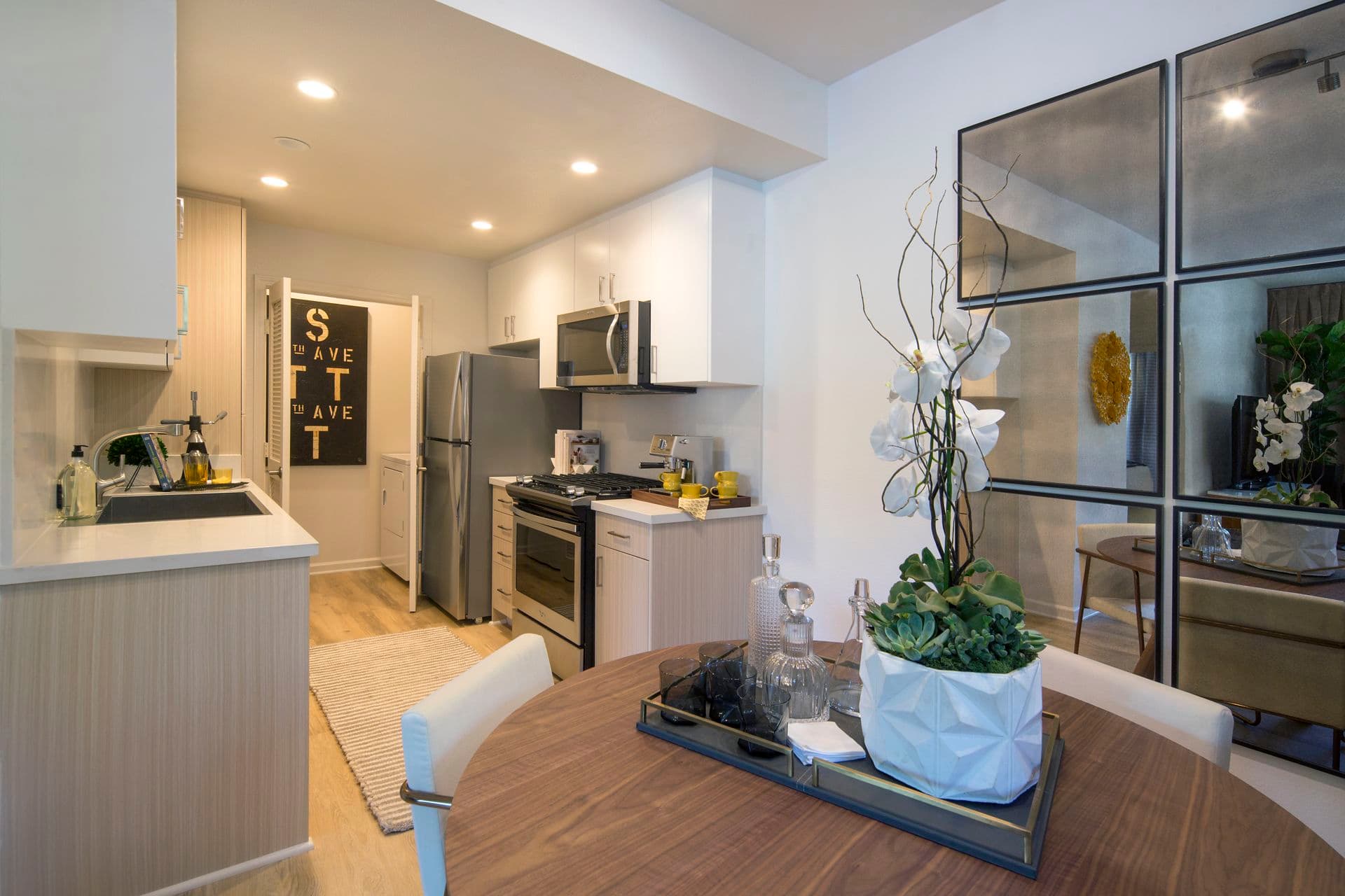 Interior view of the kitchen and dining area at The Hamptons Apartment Homes in Cupertino, CA. 