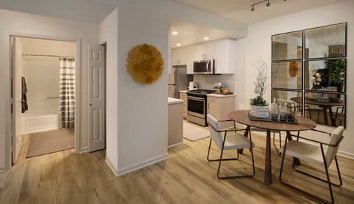Interior view of the kitchen and dining area at The Hamptons Apartment Homes in Cupertino, CA. 