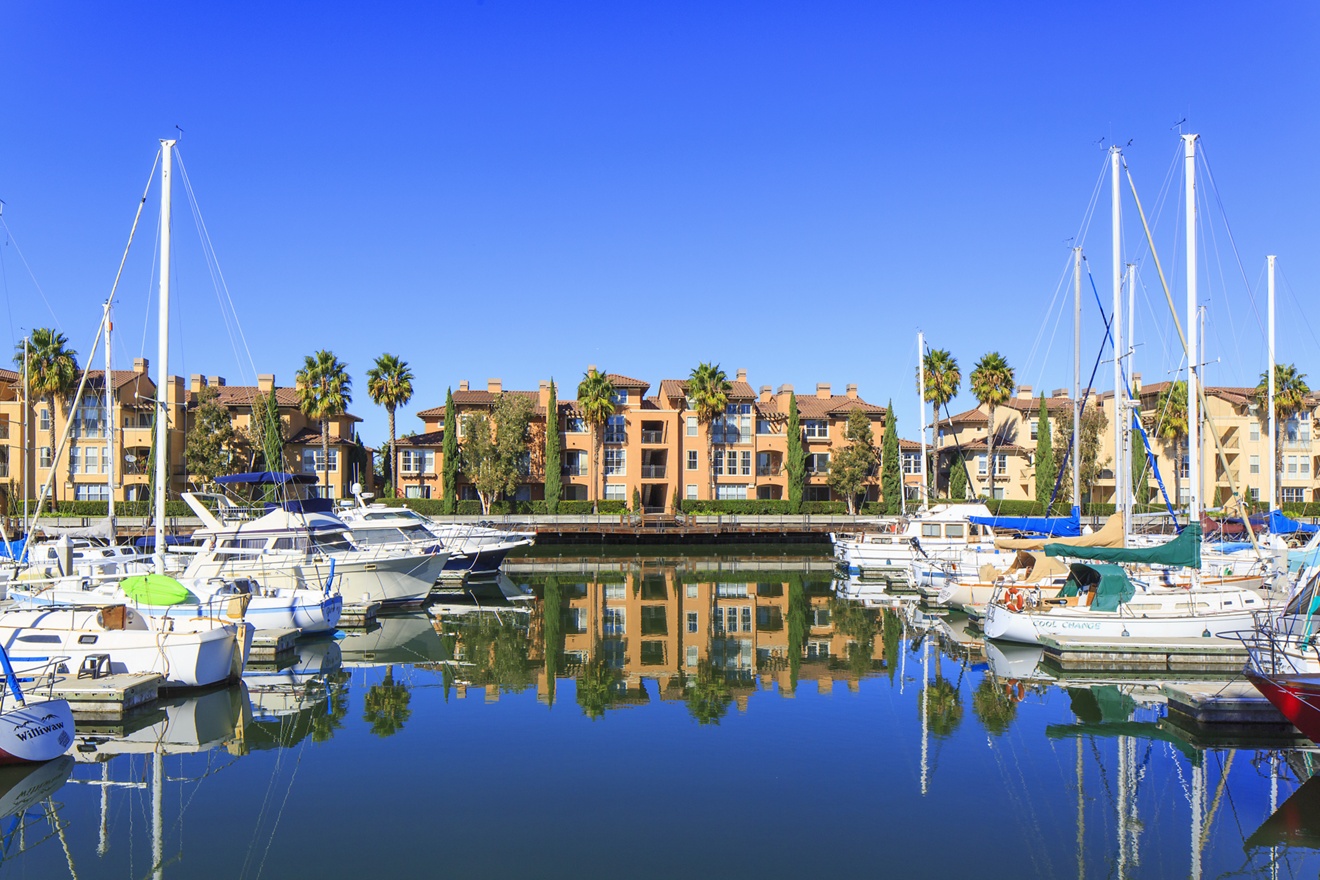 View of building exterior and waterfront bay views at The Villas at Bair Island Apartment Homes in Redwood City, CA. 