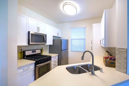 Interior view of a kitchen at Vista Bella Apartment Homes in Aliso Viejo, CA. 