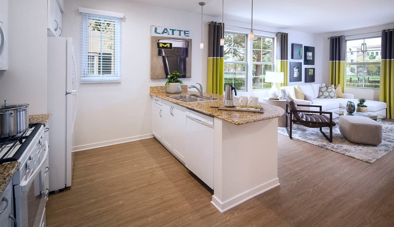 Interior view of living room and kitchen at The Enclave Apartment Homes in Costa Mesa.