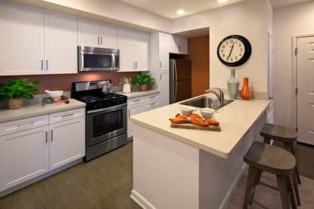 Interior view of kitchen at Avella Apartment Homes in Irvine, CA.