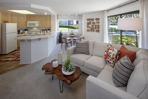 Interior view of living room, dining room and kitchen at Cross Creek Apartment Homes in Irvine, CA.