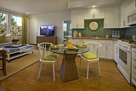 Interior view of living room and kitchen at Umbria Apartment Homes at Cypress Village in Irvine, CA.