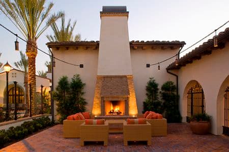 Exterior view of outdoor fireplace at Esperanza Apartment Homes in Irvine, CA.