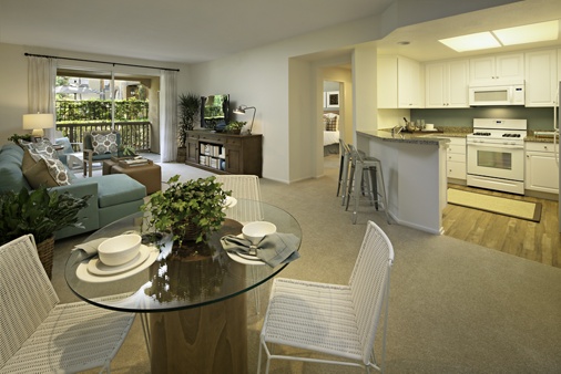 Interior view of dining room, kitchen, and living room at Estancia Apartment Homes in Irvine, CA. 