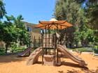 Exterior view of children's play area at Las Palmas Apartment Homes in Irvine, CA.