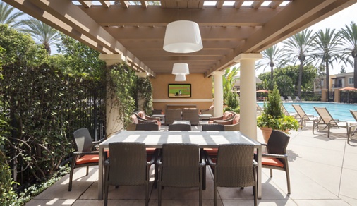 Exterior view of pool patio at Las Palmas Apartment Homes in Irvine, CA.