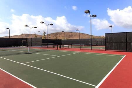 Exterior view of tennis court at Los Olivos Apartment Homes at Irvine Spectrum in Irvine, CA.