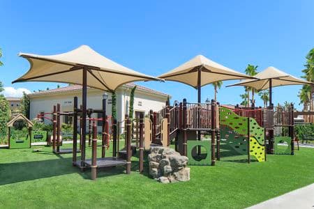 Exterior view of children's play area at Los Olivos Apartment Homes at Irvine Spectrum in Irvine, CA.