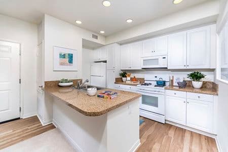 Interior view of kitchen at Los Olivos Apartment Homes at Irvine Spectrum in Irvine, CA.