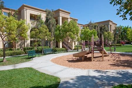 Exterior view of children's play area at Oak Glen Apartment Homes in Irvine, CA.