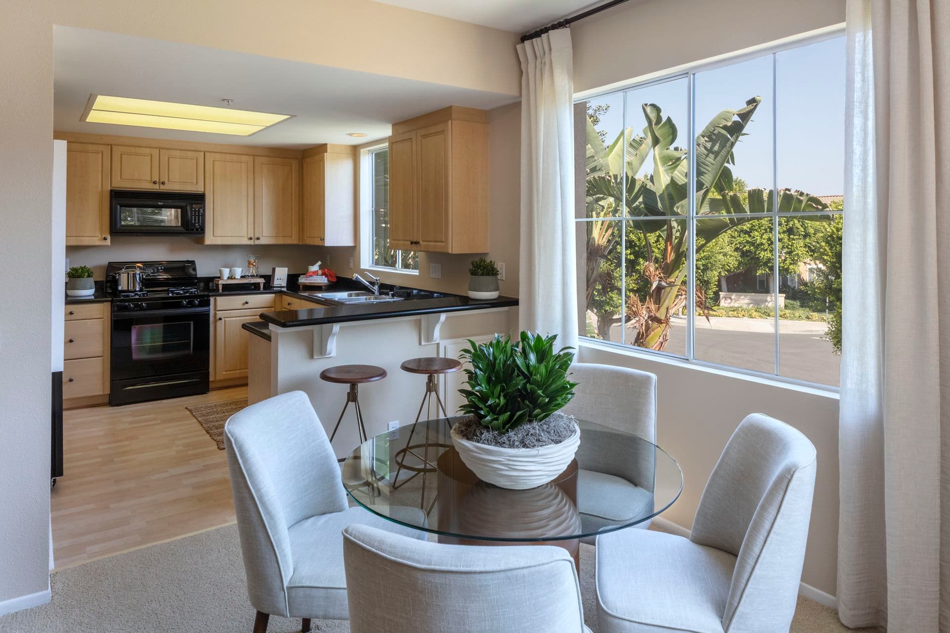 Interior view of kitchen and dining room at Santa Clara Apartment Homes in Irvine, CA.