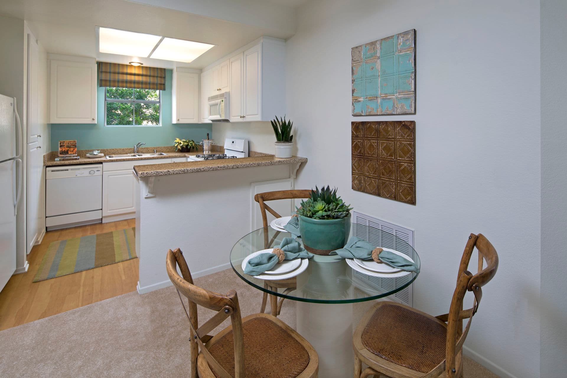 Interior view of kitchen and dining room at Santa Rosa Apartment Homes in Irvine, CA.