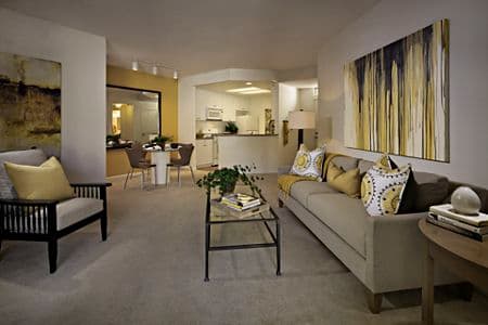 Interior view of living room, dining room, and kitchen at Santa Rosa Apartment Homes in Irvine, CA.