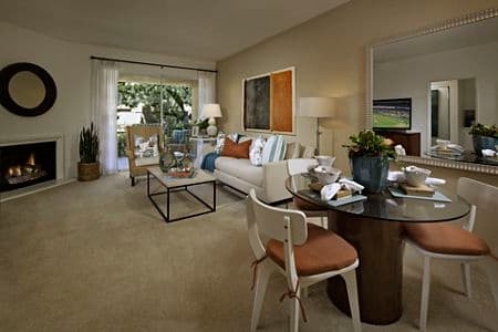 Interior view of living room and dining room at Santa Rosa Apartment Homes in Irvine, CA.