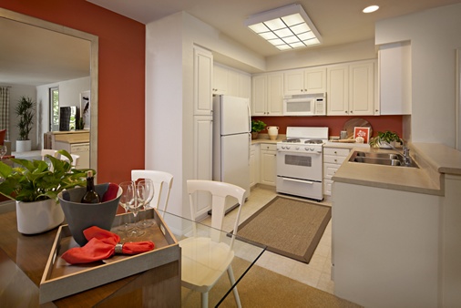 Exterior view of kitchen and dining room at Serrano Apartment Homes in Irvine, CA.