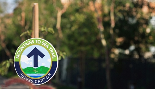 Exterior view of Peters Canyon Trail sign at Somerset Apartment Homes in Irvine, CA.