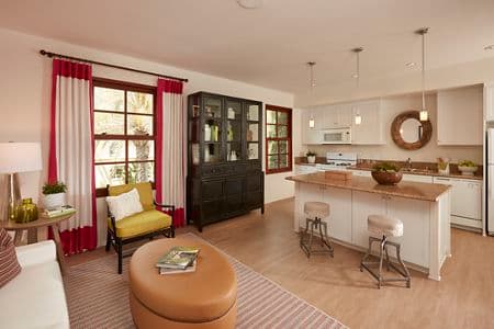 Interior view of kitchen and living room at The Park at Irvine Spectrum Apartment Homes in Irvine, CA.