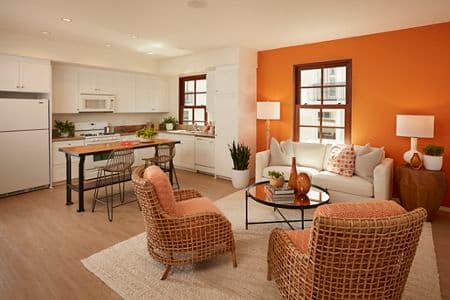 Interior view of kitchen and living room at The Park at Irvine Spectrum Apartment Homes in Irvine, CA.