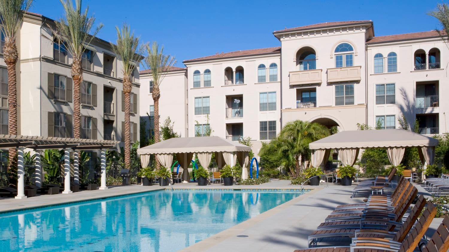 Exterior view of pool at The Village Delrey at Irvine Spectrum Apartment Homes in Irvine, CA.