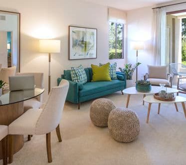 Interior view of living room and dining room at Ambrose Apartment Homes at University Town Center in Irvine, CA.
