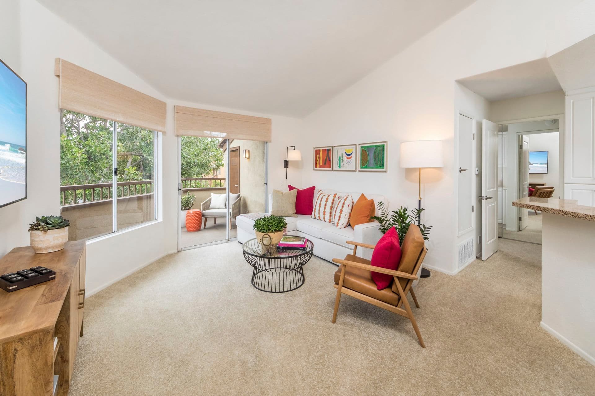 Interior view of kitchen, dining room and living room with workstation at Harvard Court Apartment Homes at University Town Center in Irvine, CA.