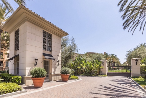 Exterior view of entry with guard gate at Villa Siena Apartment Homes in Irvine, CA.