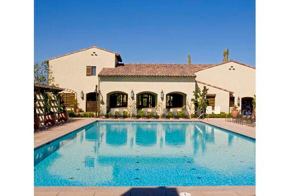 Exterior view of pool at Woodbury Court Apartment Homes in Irvine, CA.