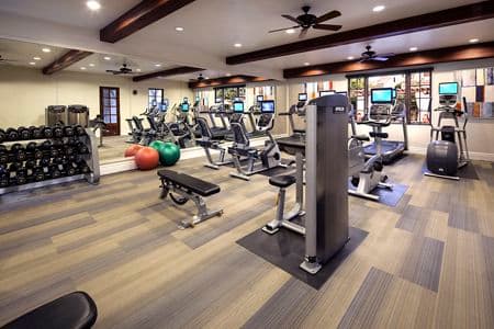 Interior view of fitness center at Woodbury Place Apartment Homes in Irvine, CA.