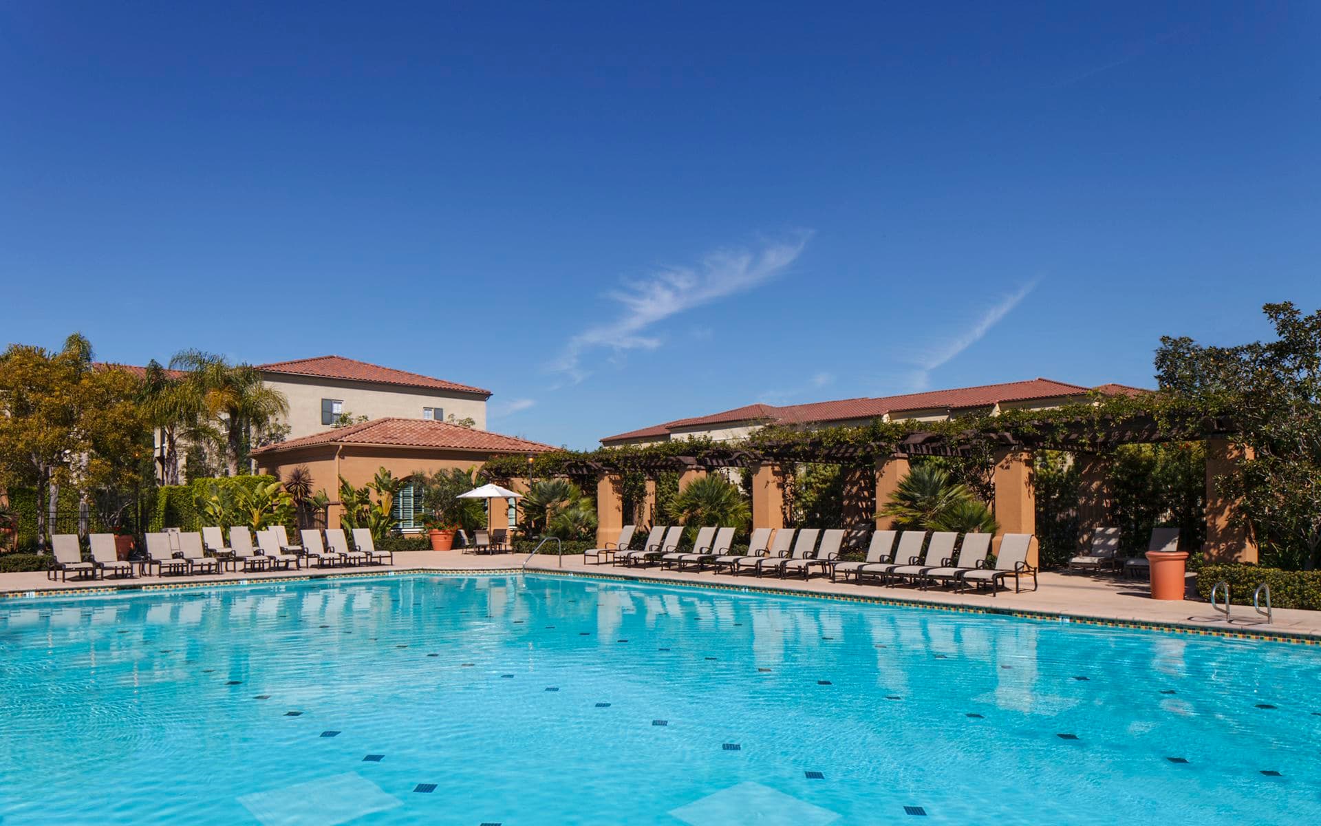 Exterior view of pool at Woodbury Square Apartment Homes in Irvine, CA.