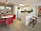 Interior view of kitchen and dining room at Woodbury Square Apartment Homes in Irvine, CA.