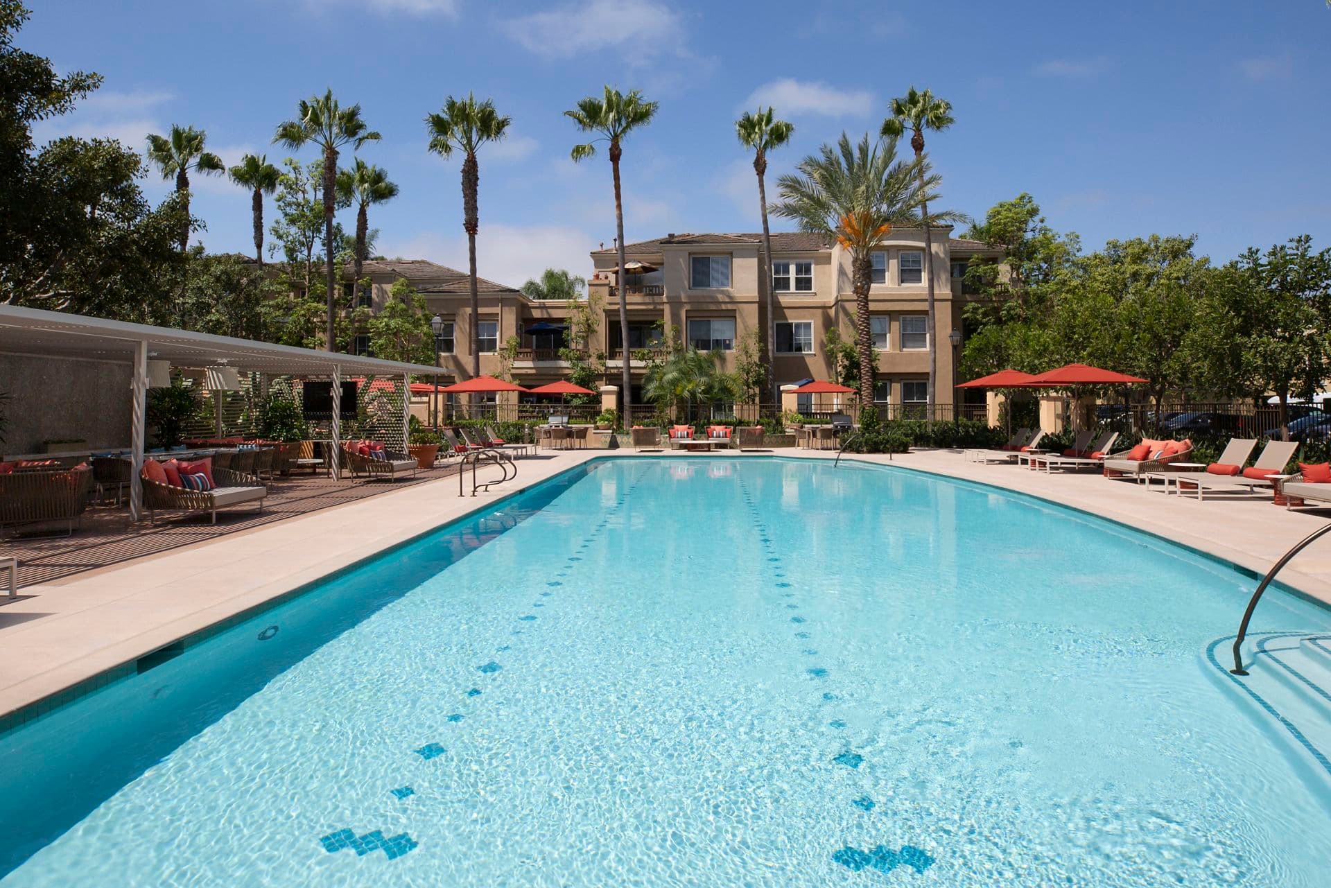 Exterior view of pool at Baypointe Apartment Homes in Newport Beach, CA.