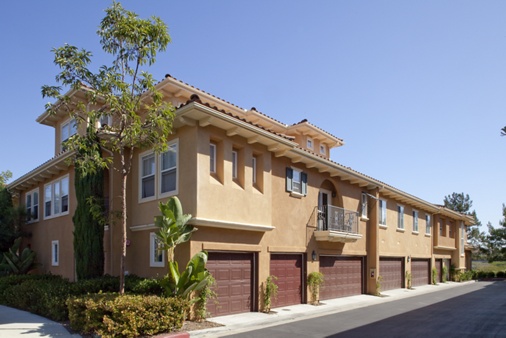 View of building exterior and garages at Newport Bluffs Apartment Homes in Newport Beach, CA. 