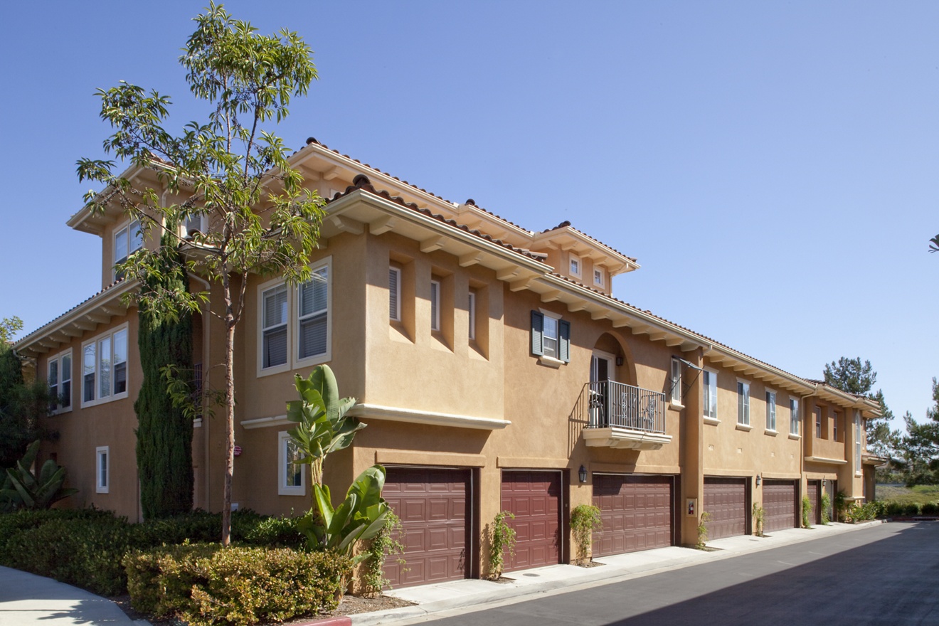 View of building exterior and garages at Newport Bluffs Apartment Homes in Newport Beach, CA. 