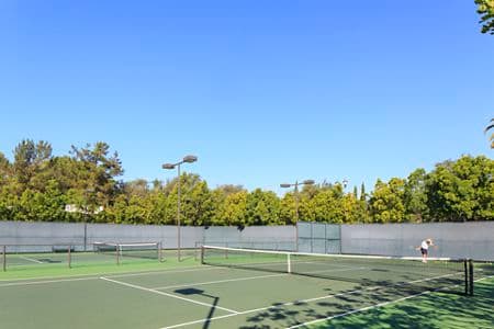 Exterior view of a tennis court at Newport Bluffs Apartment Homes in Newport Beach, CA. 