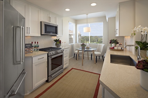 Interior view of kitchen and dining room at The Colony at Fashion Island Apartment Homes in Newport Beach, CA.