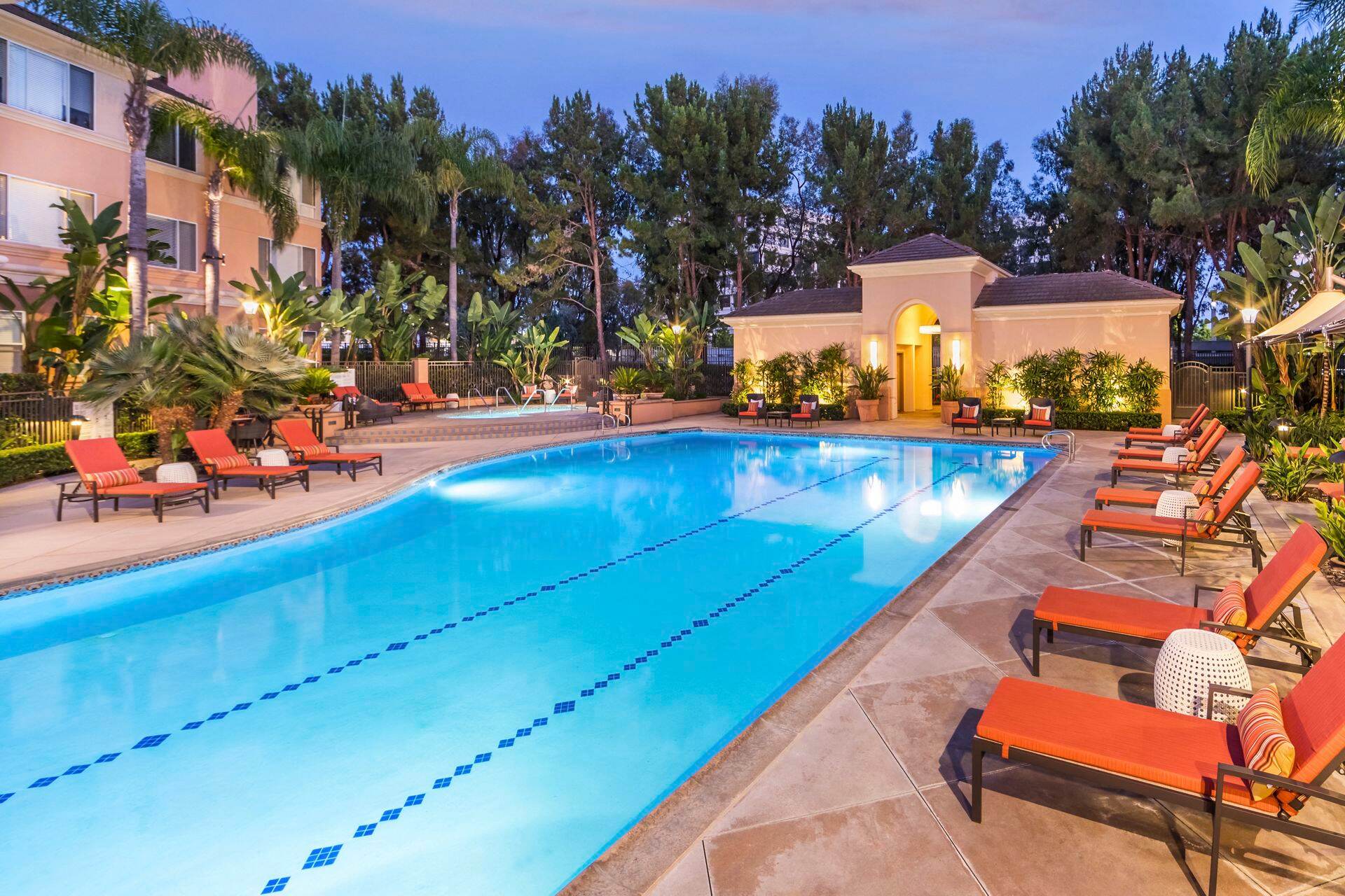Exterior dusk view of pool at The Colony at Fashion Island Apartment Homes in Newport Beach, CA.