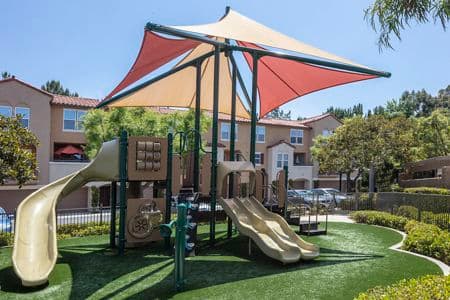 Exterior view of playground at Turtle Ridge Apartment Homes in Newport Beach, CA.