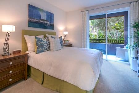 Interior views of bedroom and patio at Gateway Apartment Homes in Orange, CA.