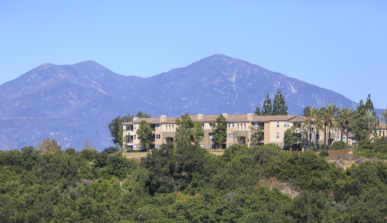 View of building exterior at Las Flores Apartment Homes in Rancho Santa Margarita, CA.