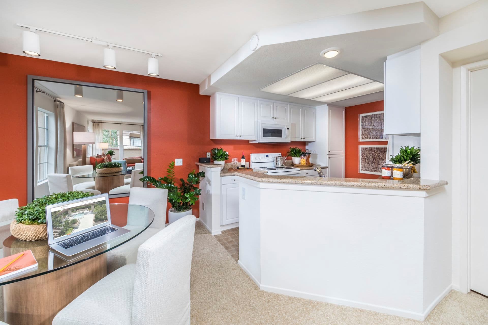 Interior view of kitchen and dining room at Rancho Maderas Apartment Homes in Tustin, CA.